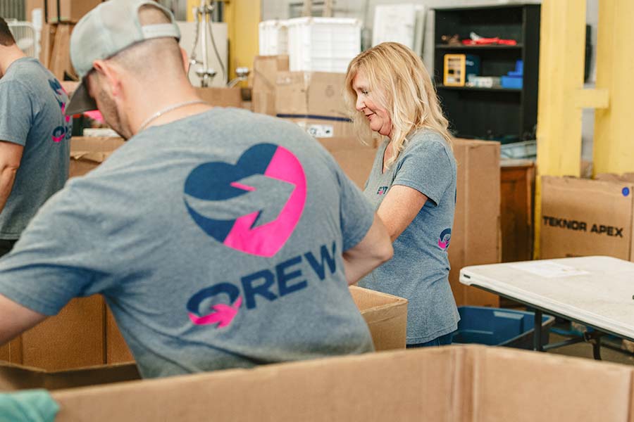 Three EQT employees work at a volunteer event.